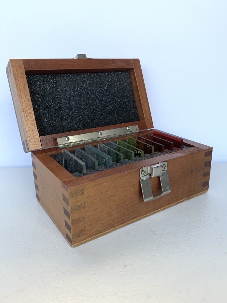 Box containing colored glass slides. Part of the How we perceive color kit.