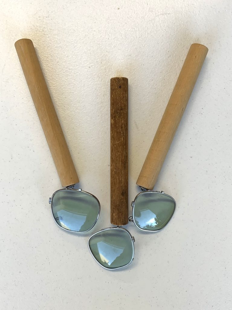 Tinted sunglass lenses fixed on a wooden dowel. Part of the How We Perceive Color kit.