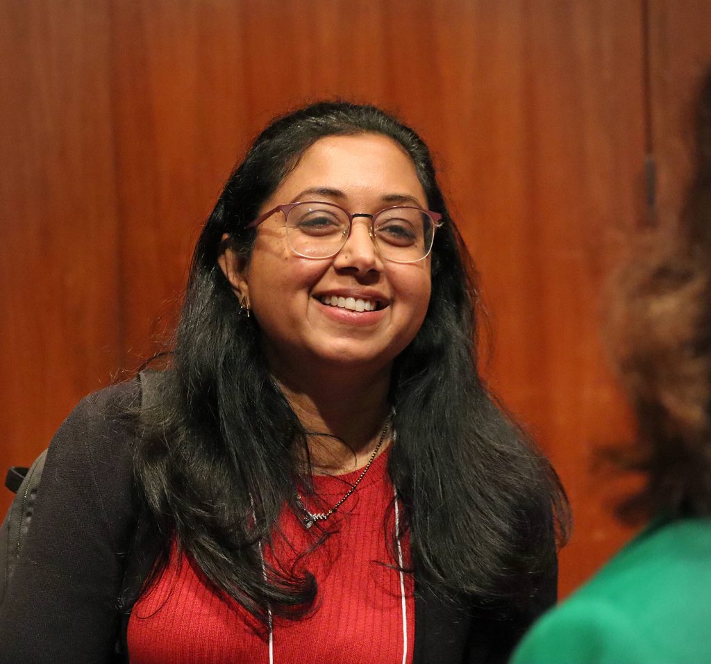 Dr. Amitha Domalpally discusses her research with an audience member after the event.
