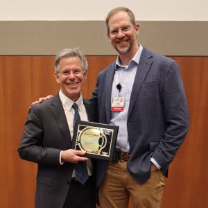 David Wilson and Dave Gamm posing with an award plaque at the 2nd Annual Daniel M Albert Lecture.