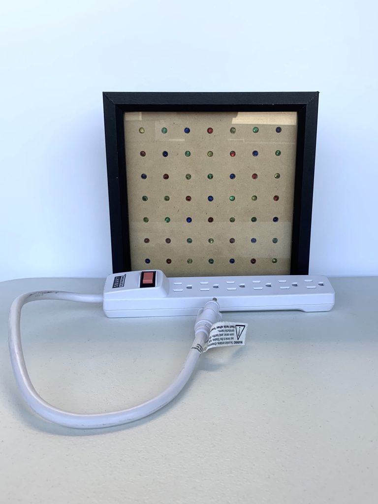 Power strip and display box containing different colored lights. Part of the How We Perceive Color kit.