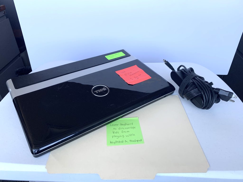 A picture of a laptop and charging cable.